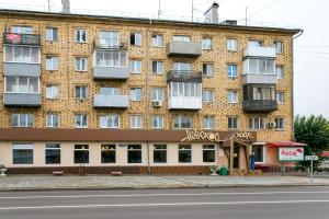 a large brick building on the side of a street at Five Stars Perfect Comfort in Krasnoyarsk