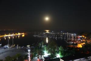 a full moon over a marina at night at Finike Marina Hotel in Finike