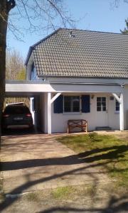 a house with a car parked in front of it at Haus Sturmschwalbe in Ummanz