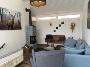 a living room with a blue couch and a fireplace at Casa Müller in Lissendorf
