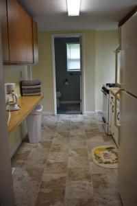 an empty kitchen with a sink and a refrigerator at Cozy 2 Bedroom House in Adrian