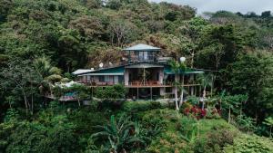 a house in the middle of a mountain at Santa Teresa Surf Vista Villas in Santa Teresa Beach