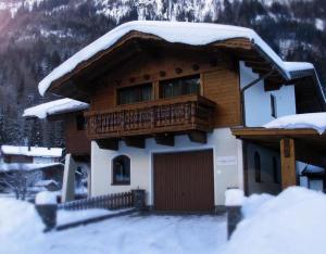 a building with a balcony with snow on it at Chalet Walzl in Längenfeld