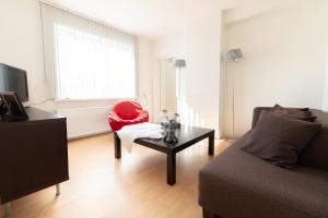 a living room with a couch and a table at Appartement Schin op Geul in Schin op Geul