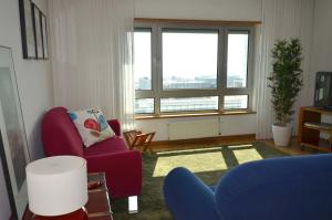 a living room with two chairs and a large window at Expo Oriente Lis in Lisbon