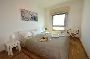 a bedroom with a bed with a tray of fruit on it at Expo Oriente Lis in Lisbon