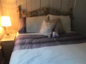 a bed with two pillows on top of it at Garden Cottage in Gartocharn