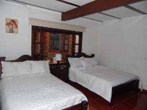 Cama o camas de una habitación en Hospederia Villa Berenita