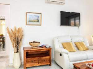 a living room with a white couch and a table at Apartment Island of Riviera Golf by Interhome in Sitio de Calahonda +30 photos