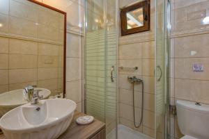 a bathroom with a sink and a shower at Sea Esta in Argassi +19 photos
