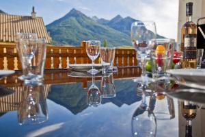 a table with wine glasses sitting on top of it at Apartment Briancon in Briançon
