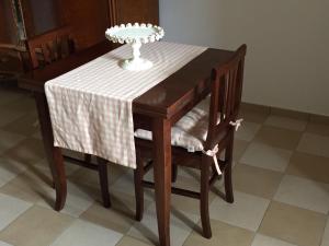a table and chairs with a plate on top of it at Villa Caterina in Sapri