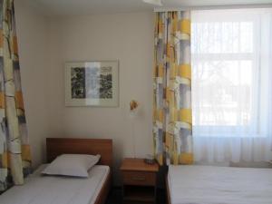 Postel nebo postele na pokoji v ubytování Livonija