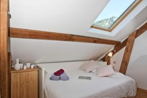 a bedroom with a bed with a laptop on it at Apartment Briancon in Briançon