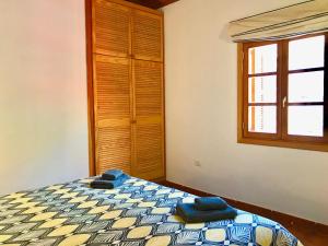 a bedroom with a bed with blue towels on it at Casita Brego - A Tranquil and Restful Rural Retreat! in San Sebastián de la Gomera