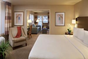 a hotel room with a large bed and a living room at Silver Cloud Hotel - Seattle Lake Union in Seattle