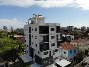 a tall white building in the middle of a city at Hotel Kapital in Maputo