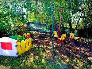 a childrens playground with a swing and a swing at Quinta Da Ilda in Loulé