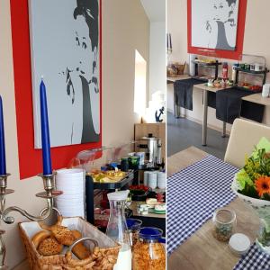 a dining room with a table with food and a candle at Hotel Garni in Herborn
