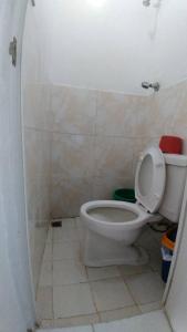 a bathroom with a toilet with the lid up at Dahilig Resort in Puerto Galera