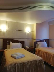 a hotel room with two beds with towels on them at Hotel "VIRGEN DEL SOCAVON" in Oruro +91 photos