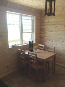 a wooden dining room with a table and chairs at Farm Retreat with 2 Bed Roms perfect for 4 Guests! in Deep Brook