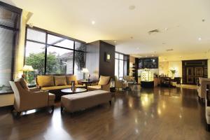 a living room with a couch and a table at Hotel Santika Premiere Jogja in Yogyakarta