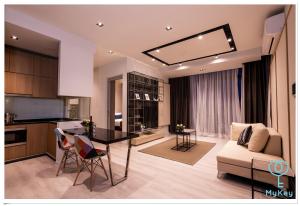 eine Küche und ein Wohnzimmer mit einem Tisch und einem Sofa in der Unterkunft Expressionz Professional Suites by MyKey Global in Kuala Lumpur