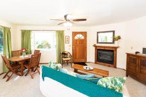 a living room with a couch and a table at 'Ama'u Lani Cottage in Volcano