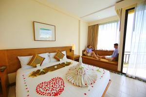 a hotel room with a bed with a heart decoration on it at Supalai Scenic Bay Resort And Spa, SHA Extra Plus in Por Bay
