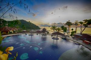 a large swimming pool with a view of the water at Supalai Scenic Bay Resort And Spa, SHA Extra Plus in Por Bay