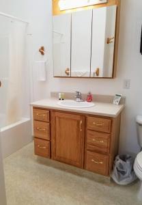 a bathroom with a sink and a mirror at Zion's Most Wanted Hotel in Hildale