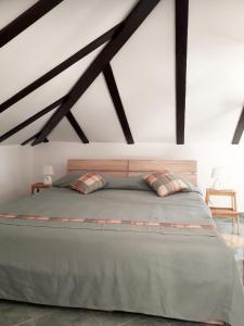 a bedroom with a large bed in a loft at Guest House Klaudija in Trogir