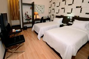 Postel nebo postele na pokoji v ubytování Hotel Tebrau CT + 4 fotografie