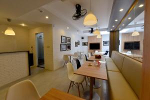 a restaurant with tables and chairs and a counter at Phu My Hung - Saigon South Serviced Apartments - Near Vivo City Mall in Ho Chi Minh City