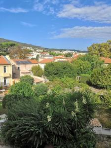 a view of a garden with plants and buildings at Les Lavandes in La Ciotat