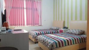 Postel nebo postele na pokoji v ubytování Da Yi Train Homestay