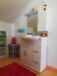 a bathroom with a sink and a mirror at Peaceful View Apartment in Koper