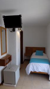 Postel nebo postele na pokoji v ubytování Hotel Concorde