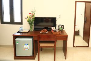 En tv och/eller ett underhållningssystem på Hacom Galaxy Hotel