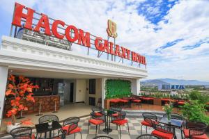 a restaurant with red chairs and tables on a patio at Hacom Galaxy Hotel in Phan Rang–Tháp Chàm