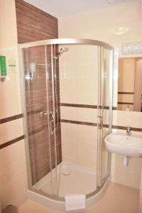 a bathroom with a shower and a sink at Hotel Nekla in Nekla