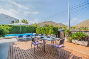 a patio with a table and chairs and a pool at Villa Maria in El Port