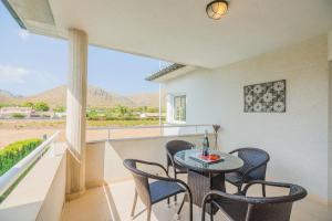 a table and chairs on a balcony with a view at Villa Maria in El Port