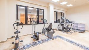 a gym with treadmills and elliptical machines at Silvermine Beach Resort in Hong Kong
