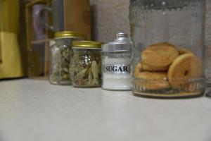 a counter top with jars of food and bread at Alindro City Center Apartment 2 in Tirana