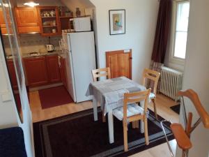 a kitchen with a table and chairs and a refrigerator at FirstHome GuestHouse in Pietarsaari