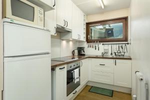 a kitchen with white cabinets and a window at Apartment Lyret in Chamonix