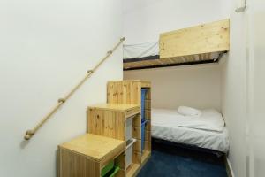a room with two bunk beds and two tables at Apartment Lyret in Chamonix