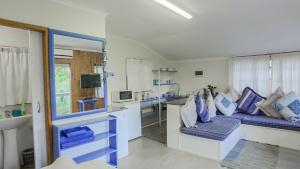 a kitchen with blue and white counters and a couch at Suzy's Place in Port Edward